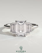 Kynora CJ 2ct emerald claw trilogy engagement ring with graduating baguette shoulder stones, three-stone diamond ring.