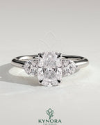 Kynora CJ 2ct elongated cushion claw trilogy engagement ring with round side stones and delicate lily detail in silver setting