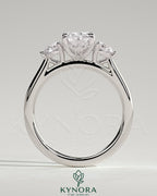 Kynora CJ 2ct elongated cushion claw trilogy engagement ring with round side stones and lily detailing in sterling silver.