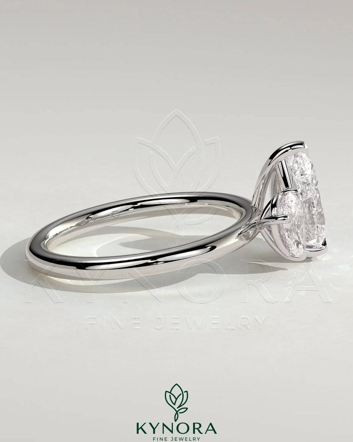 Kynora CJ 0.5ct and 1.25ct pear-shaped Toi et Moi engagement ring with claw settings and intricate band design.