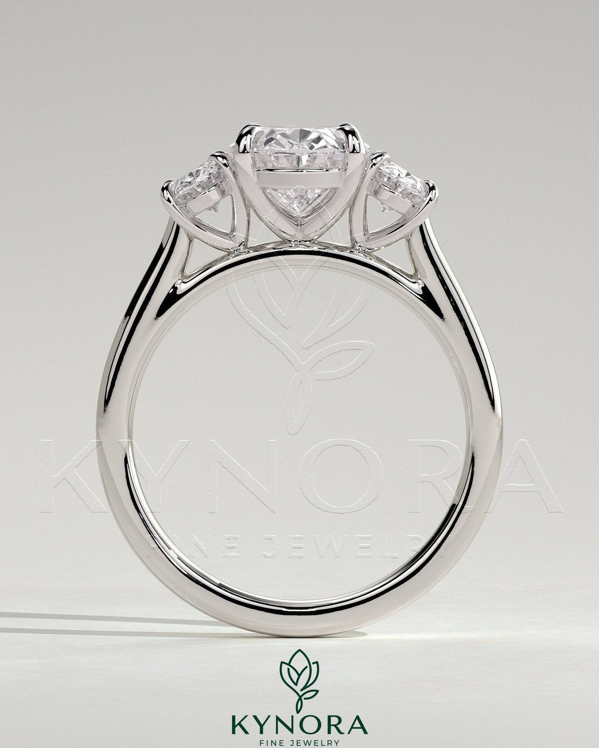 Kynora CJ 2ct oval claw trilogy engagement ring with oval side stones, showcasing elegant three-stone diamond design.