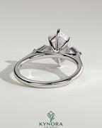 Kynora CJ 2ct elongated hexagon claw trilogy engagement ring with kite side stones, three-stone design, sparkling diamond accents