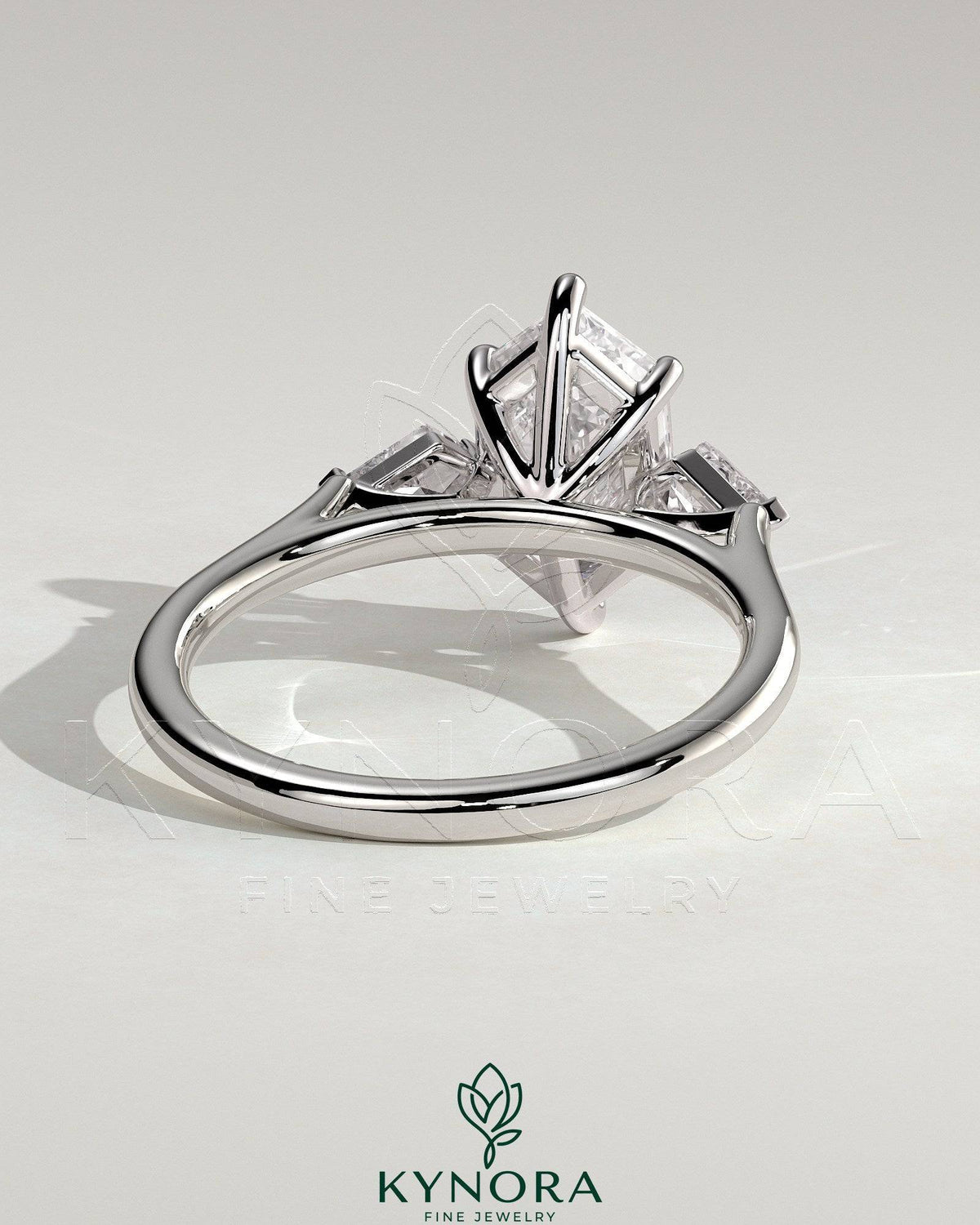 Kynora CJ 2ct elongated hexagon claw trilogy engagement ring with kite side stones, three-stone design, sparkling diamond accents