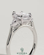 Kynora CJ 2ct elongated hexagon claw trilogy engagement ring with kite side stones, three-stone design in sterling silver.
