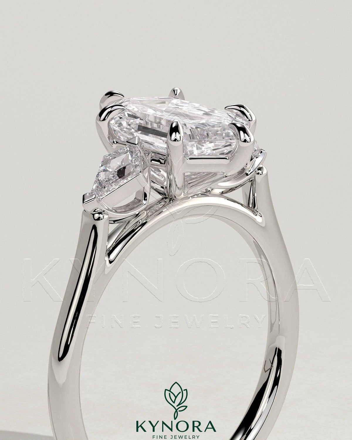 Kynora CJ 2ct elongated hexagon claw trilogy engagement ring with kite side stones, three-stone design in sterling silver.