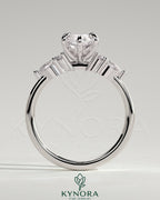 Kynora CJ three-stone engagement ring featuring a 2-carat marquise claw-set center with pear-shaped accents and round shoulder stones.