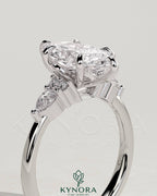 Kynora CJ 2ct marquise claw solitaire engagement ring with pear-shaped accents and round shoulder stones, elegant three-stone design