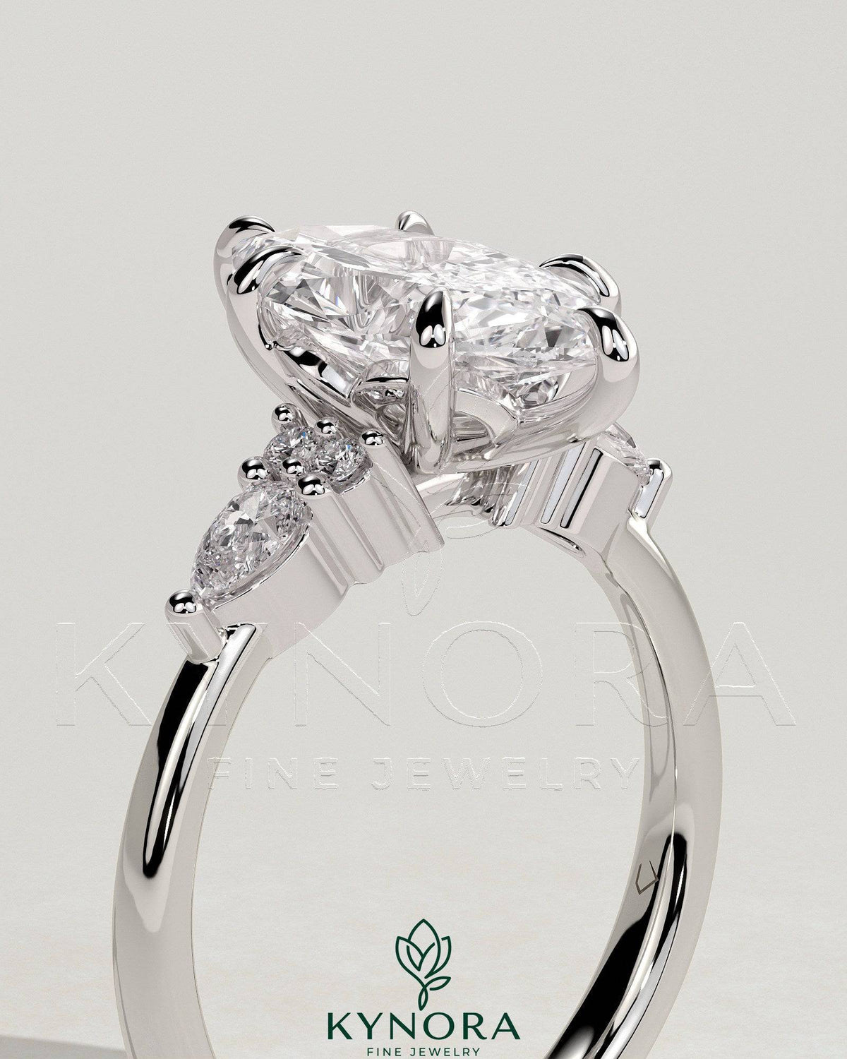 Kynora CJ 2ct marquise claw solitaire engagement ring with pear-shaped accents and round shoulder stones, elegant three-stone design