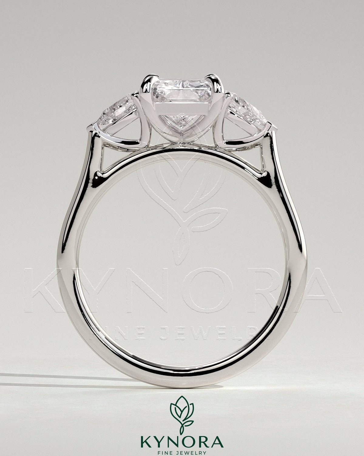 Kynora CJ 2ct radiant claw trilogy engagement ring with pear side stones and cathedral setting, showcasing elegant diamond craftsmanship.