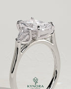 Kynora CJ 2ct radiant claw trilogy engagement ring with pear side stones and cathedral setting, showcasing sparkling fine jewelry.