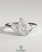 Kynora CJ 0.5ct pear-shaped diamond and 1.25ct pear-shaped diamond Toi et Moi engagement ring with claw settings.