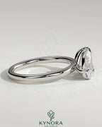 Kynora CJ 1.5ct pear-shaped and 1.8ct emerald-cut Toi et Moi engagement ring with claw settings, showcasing elegant diamond design.