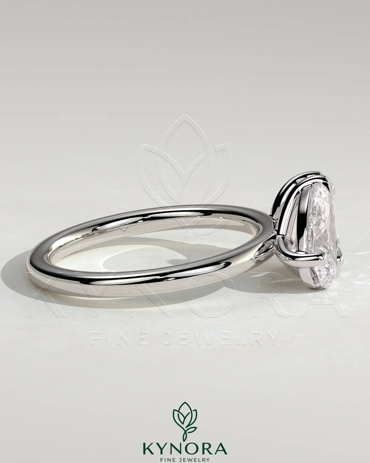 Kynora CJ 1.5ct pear-shaped and 1.8ct emerald-cut Toi et Moi engagement ring with claw settings, showcasing elegant diamond design.