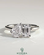 Kynora CJ Toi et Moi engagement ring featuring a 1.5ct pear-shaped and 1.8ct emerald-cut diamonds with claw settings.