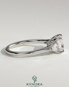 Kynora CJ 2ct cushion claw trilogy engagement ring with pear side stones and open trellis gallery design.