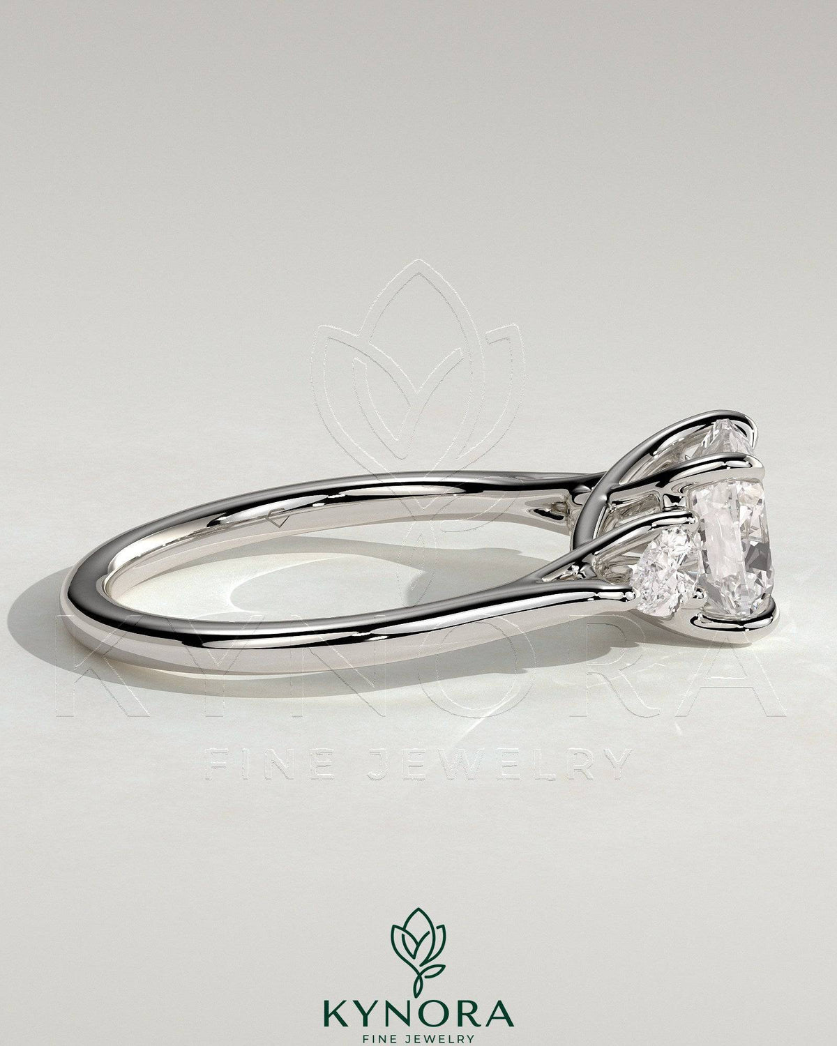 Kynora CJ 2ct cushion claw trilogy engagement ring with pear side stones and open trellis gallery design.