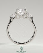 Kynora CJ cushion claw trilogy engagement ring with pear side stones and open trellis gallery design.
