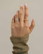 Kynora CJ 2ct cushion claw trilogy engagement ring with pear side stones and open trellis gallery design.