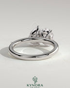 Kynora CJ Toi et Moi engagement ring featuring a 1.5ct pear-shaped and 1.5ct oval-shaped diamonds in a claw setting.