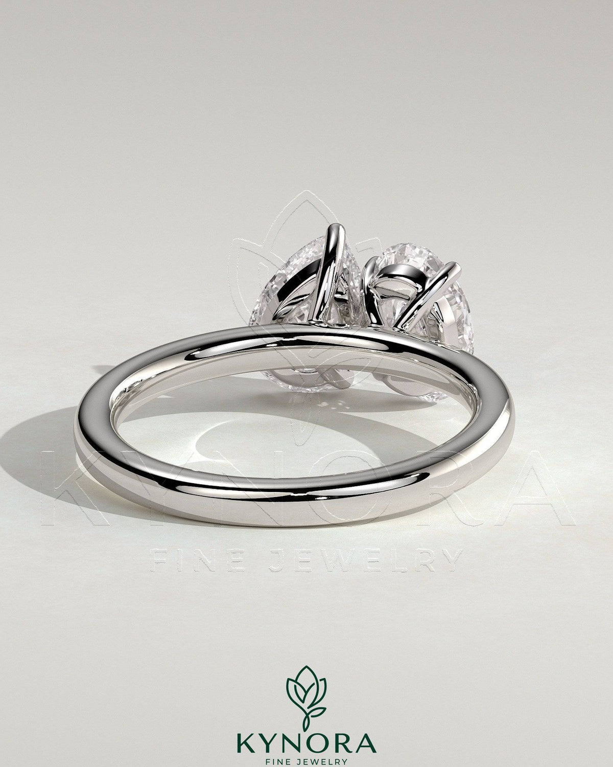 Kynora CJ Toi et Moi engagement ring featuring a 1.5ct pear-shaped and 1.5ct oval-shaped diamonds in a claw setting.
