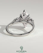 Kynora CJ 2ct marquise claw trilogy engagement ring with pear side stones and cathedral setting, showcasing elegant diamond design.