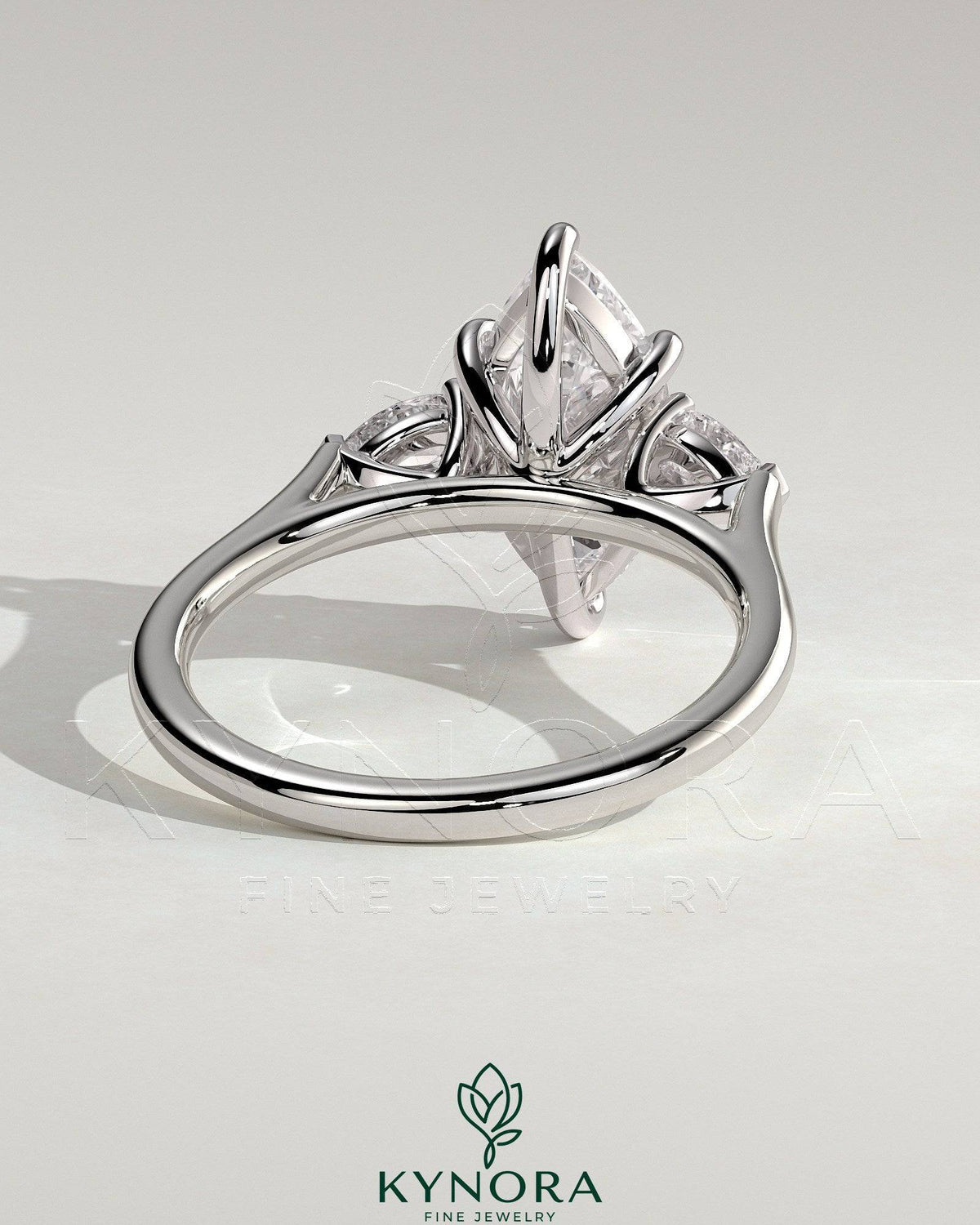 Kynora CJ 2ct marquise claw trilogy engagement ring with pear side stones and cathedral setting, showcasing elegant diamond design.