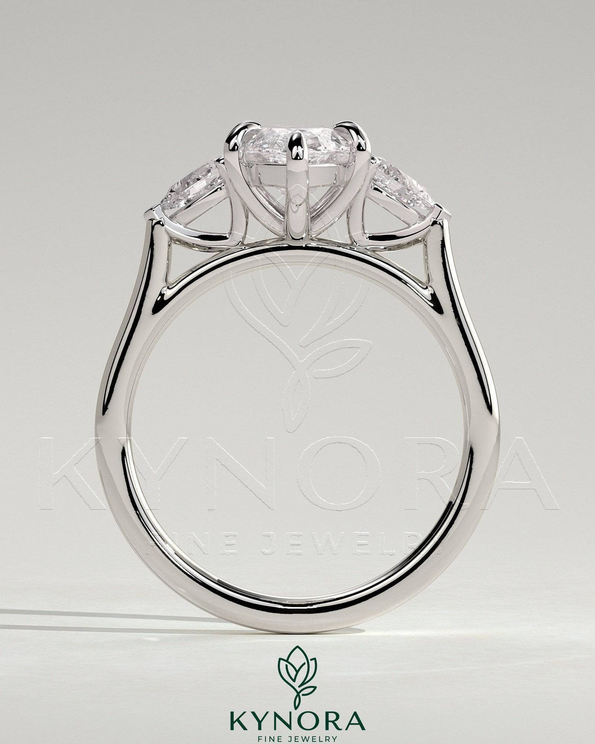 Kynora CJ 2ct marquise claw trilogy engagement ring with pear side stones and cathedral setting showcasing sparkling diamonds.