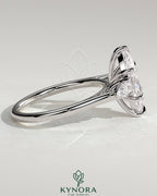 Kynora CJ 2ct marquise claw trilogy engagement ring with pear side stones in cathedral setting, showcasing elegant diamond craftsmanship.