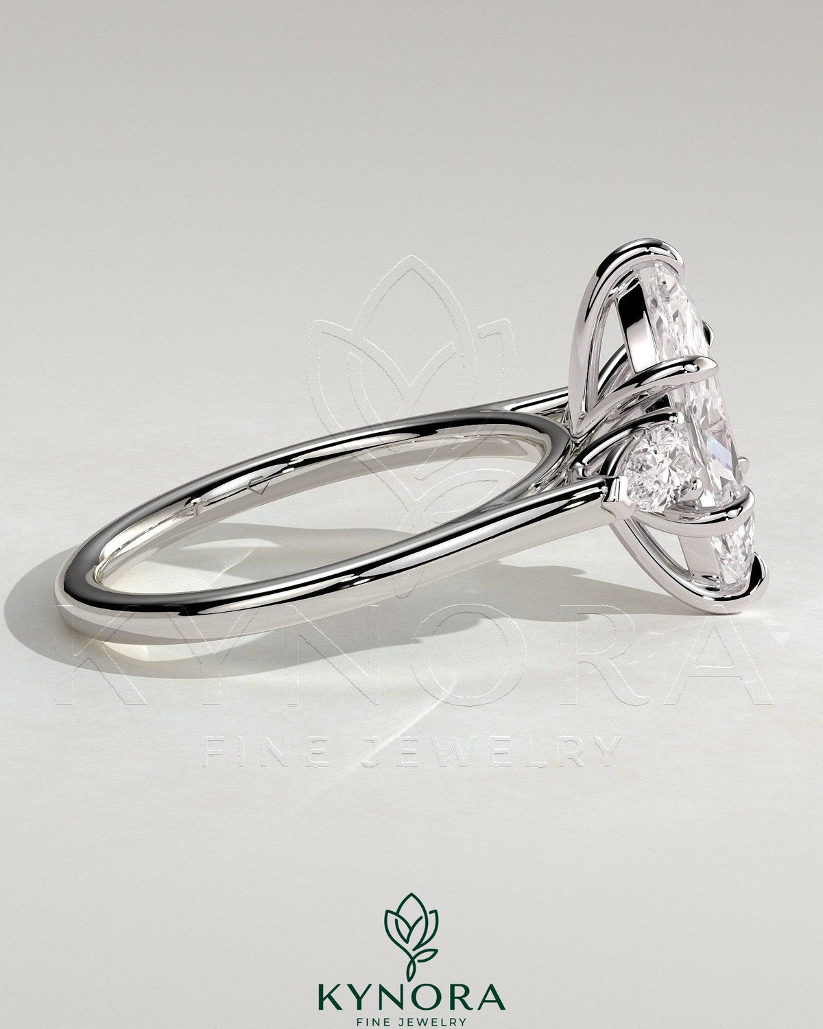 Kynora CJ 2ct marquise claw trilogy engagement ring with pear side stones in cathedral setting, showcasing elegant diamond craftsmanship.