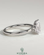 Kynora CJ Toi et Moi engagement ring featuring a 1.5ct pear-shaped and 1.5ct oval-shaped diamonds in a claw setting.