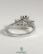 Kynora CJ 2ct oval claw trilogy engagement ring with round side stones, pave band and trellis gallery design.