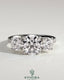 Kynora CJ three-stone engagement ring with 2ct round claws, side stones, pave band, and trellis gallery design.