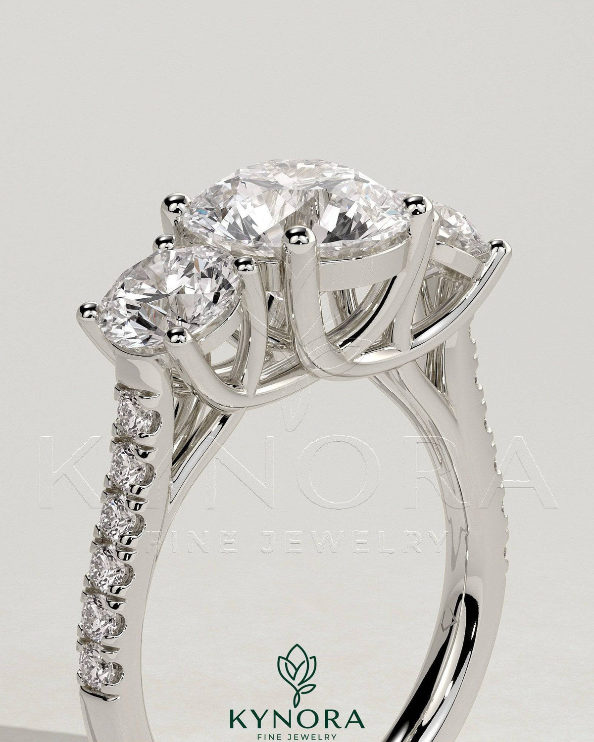 Kynora CJ 2ct round claw trilogy engagement ring with round side stones, pave band and trellis gallery design