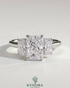 Kynora CJ classic 2ct radiant claw trilogy engagement ring with three sparkling stones and elegant band design.