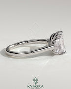 Kynora CJ classic 2 carat radiant cut three-stone engagement ring with claw settings, featuring sparkling center and side stones.