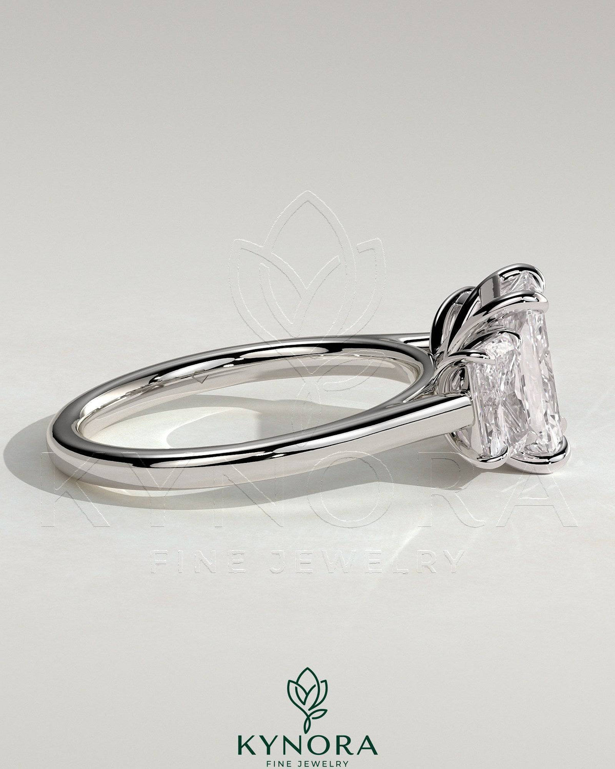 Kynora CJ classic 2 carat radiant cut three-stone engagement ring with claw settings, featuring sparkling center and side stones.