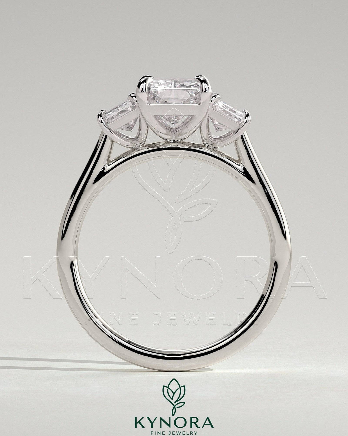 Kynora CJ classic 2-carat radiant cut three-stone engagement ring with claw setting, showcasing elegant sparkle and craftsmanship.