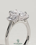 Kynora CJ Classic 2ct radiant cut three-stone engagement ring with claw setting, showcasing sparkling center stones and elegant design.