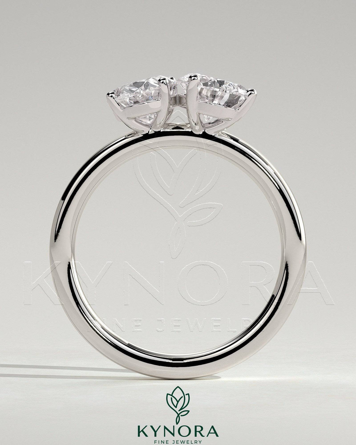 Kynora CJ 1.5ct pear and 1.5ct oval diamond Toi et Moi engagement ring with claw settings, elegant and sparkling in silver setting.