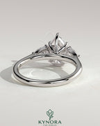 Kynora CJ 2ct pear-shaped diamond trilogy engagement ring with side stones and floating cathedral high setting.
