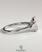 Kynora CJ 2ct pear claw trilogy engagement ring with pear side stones and floating cathedral high setting.