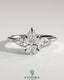 Kynora CJ three-stone engagement ring with 2-carat pear-shaped center diamond, side stones, and floating cathedral setting.