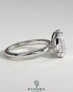 Kynora CJ Toi et Moi engagement ring featuring a 1.5ct pear-shaped diamond and a 1.8ct radiant diamond in a claw setting.