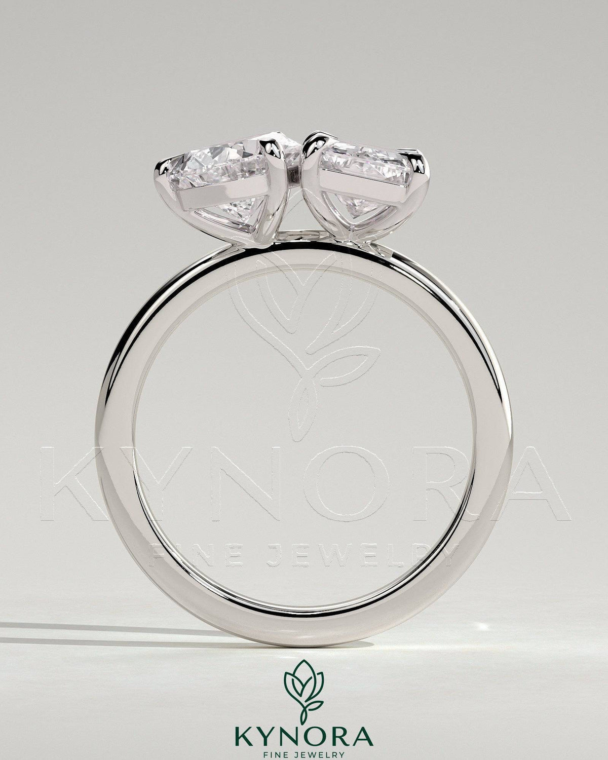 Kynora CJ Toi et Moi engagement ring with 1.5ct pear-shaped and 1.8ct radiant diamonds in a claw setting.
