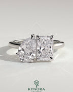 Kynora CJ Toi et Moi engagement ring with 1.5ct pear-shaped diamond and 1.8ct radiant-cut diamond in a claw setting.