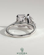 Kynora CJ Toi et Moi engagement ring with 3.3ct pear-shaped and 3.3ct emerald cut diamonds in bezel settings.