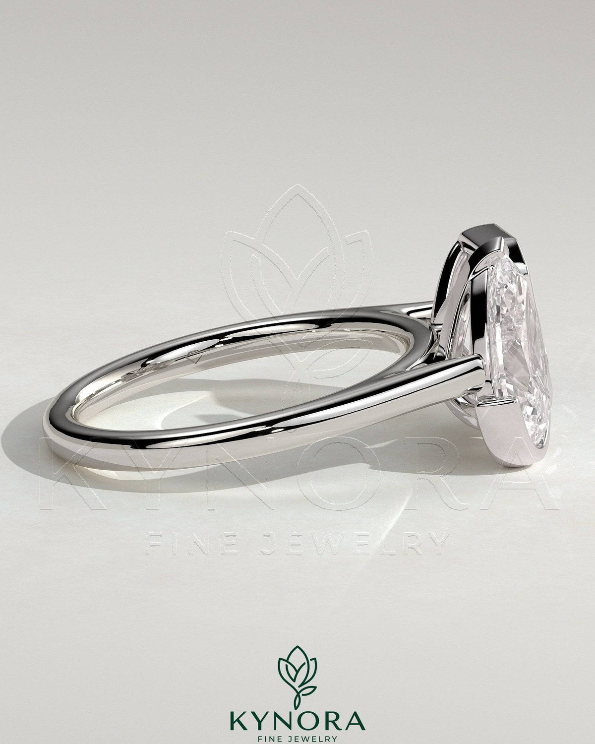 Kynora CJ 3.3ct pear and 3.3ct emerald Toi et Moi engagement ring with bezel and half-bezel setting, detailed gold band design