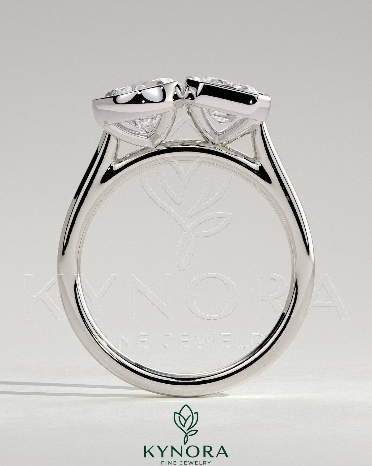 Kynora CJ 3.3ct pear-shaped and 3.3ct emerald-cut Toi et Moi engagement ring with bezel settings, detailed and elegant design