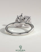 Kynora CJ 1.8ct emerald and 1.5ct pear-shaped diamonds Toi et Moi engagement ring with hidden halo setting.