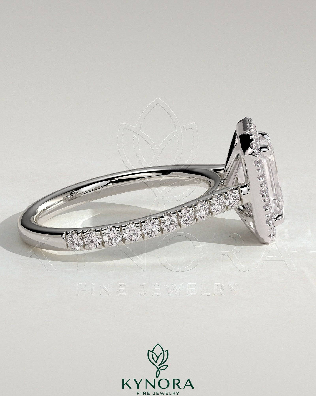 Kynora CJ 2ct emerald claw solitaire engagement ring with halo, pave band, and cathedral high setting showcasing sparkling jewelry.